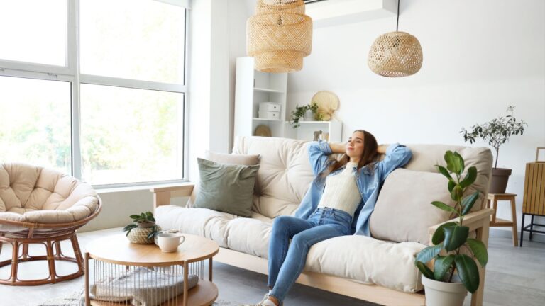 Young woman sitting on couch in living room