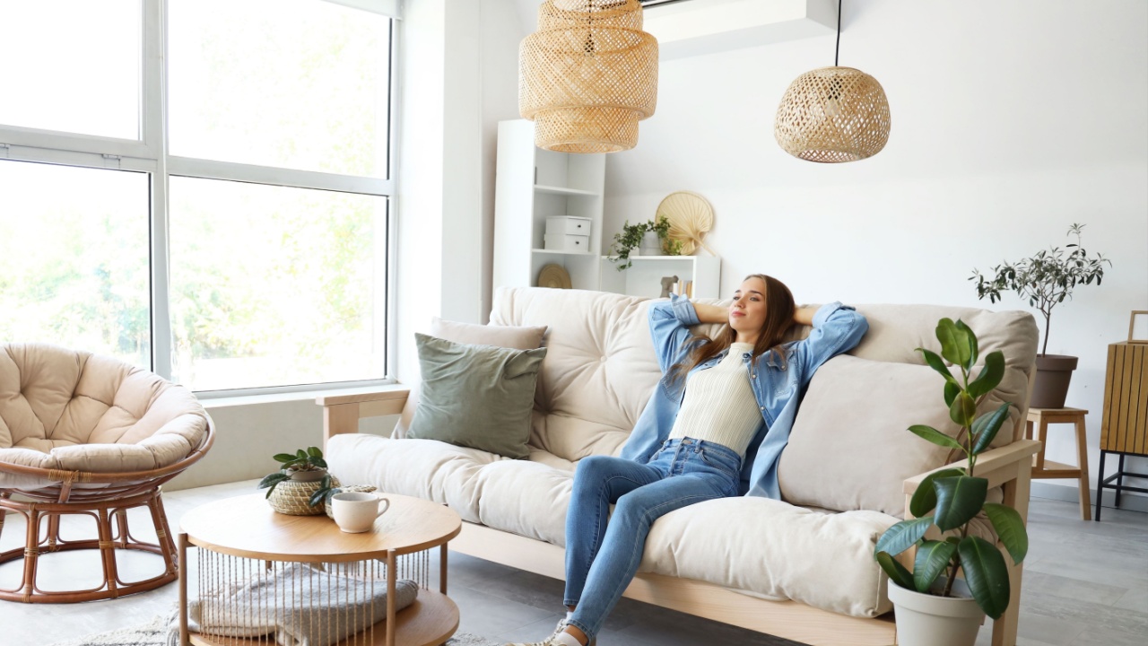 Young woman sitting on couch in living room