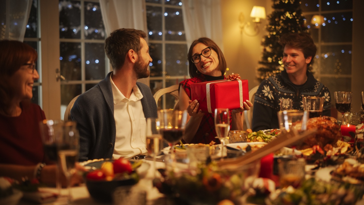 Multicultural Family Exchanging Gifts to Celebrate the Holiday. Portrait of a Beautiful Young Woman Excited to Receive a Present. Christmas Dinner Together with Parents, Children and Friends at Home