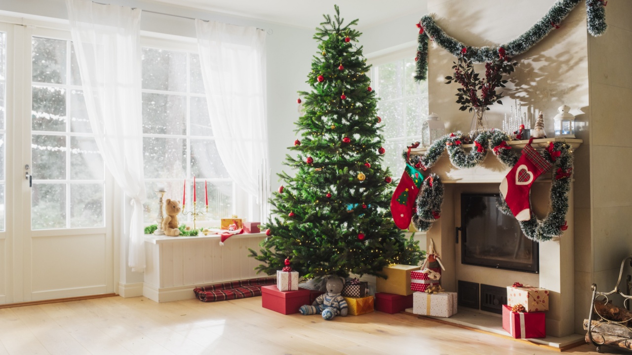 Empty Shot Depicting the Magic of Holidays on a Peaceful Snowy Christmas Morning: Close Up on Decorated Fireplace with Stockings Next to a Christmas Tree. Green and Red Garlands, Ribbons and Lights