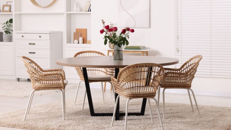 Stylish dining room interior with table and chairs.