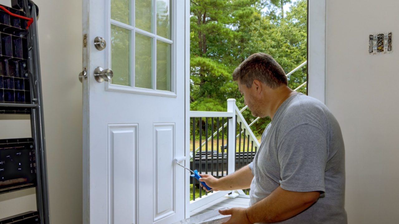 In process of renovating home, worker painted front door with paintbrush