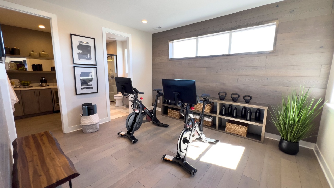 Denver, Colorado, USA-March 3, 2024-This spacious home gym boasts a clean, modern design with elegant wood paneling and large windows allowing natural light to flood the space, enhancing the workout
