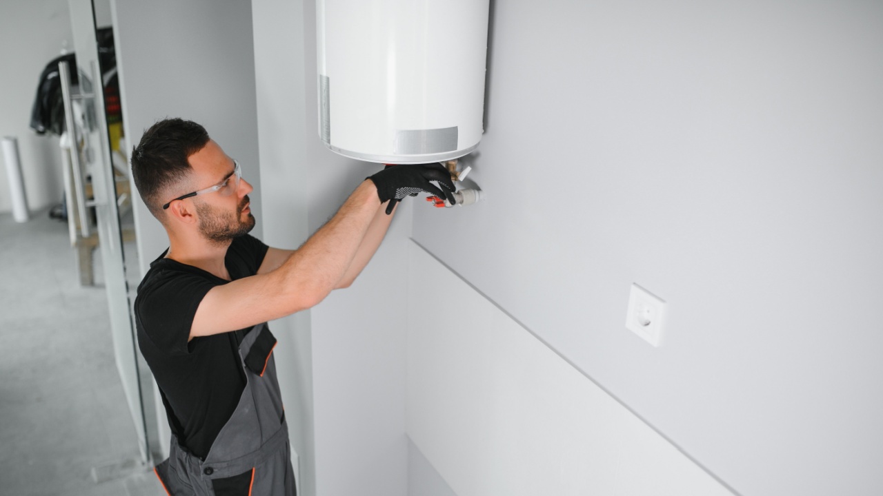 Professional plumber checking a boiler and pipes, boiler service concept.