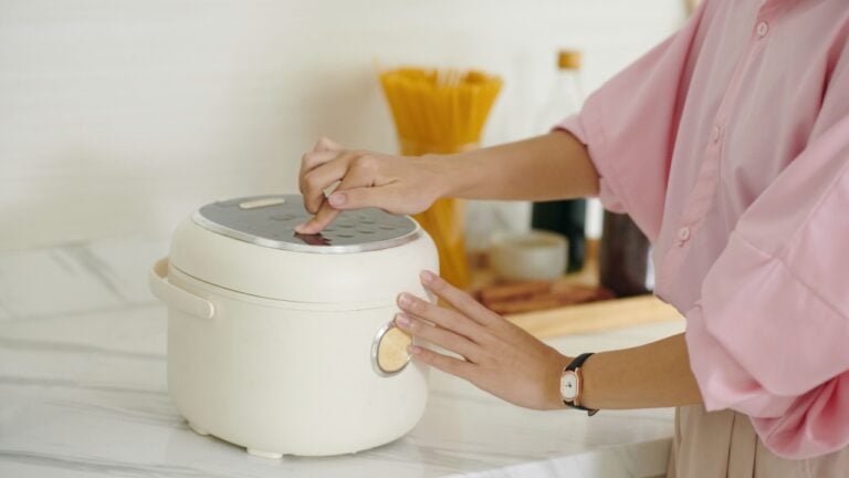 Woman Using Multicooker In The Kitchen