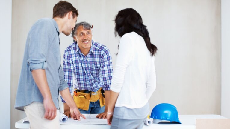 New home, architect and couple planning blueprint for construction, sketch and talk for teamwork. Smile, architecture and happy people with model design for renovation, contractor or building project