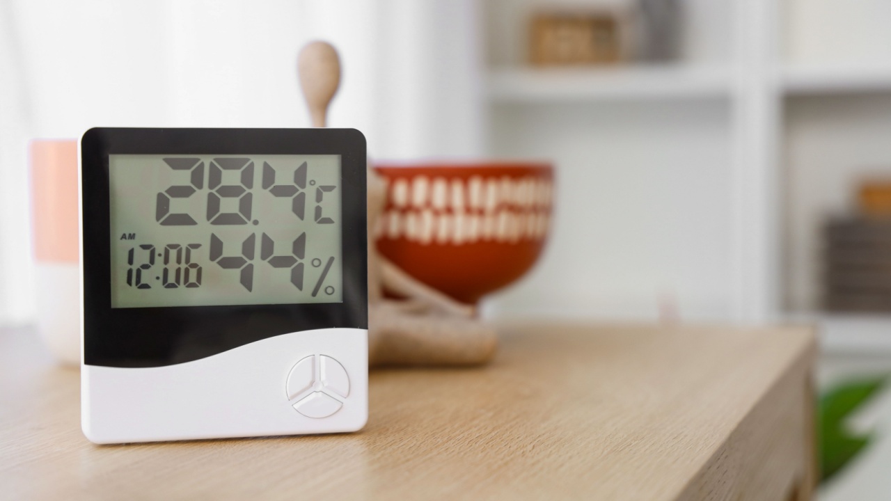 Digital hygrometer on shelf in living room, closeup