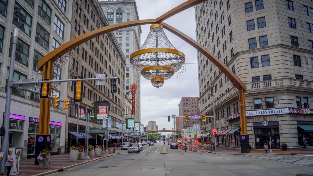 Cleveland, USA - May 8 2022: The street at Cleveland downtown, Ohio, with the business buildings, stores, cars on the road, and high-rise American office, USA.