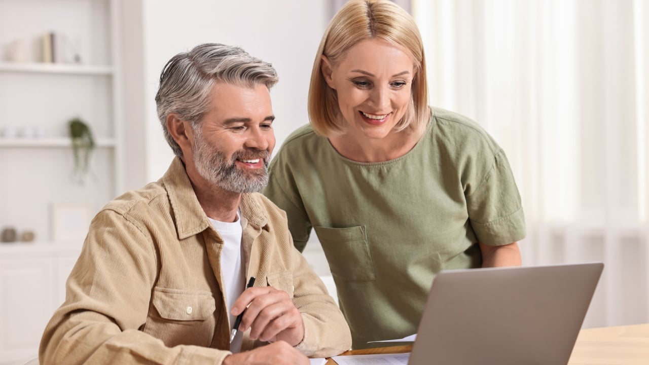 Couple planning pension budget at table indoors