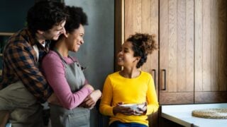 Happy multiethnic family in love together in kitchen. Parents child together.