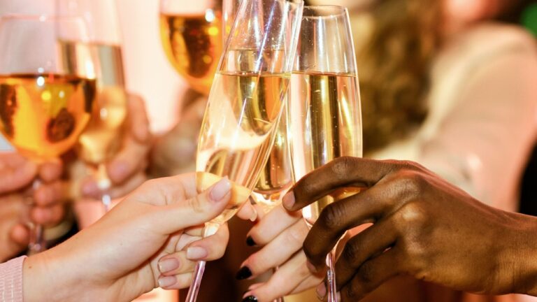 Cheers. Unrecognizable Young People Clinking Champagne Glasses Celebrating New Year Indoor. Closeup, Selective Focus