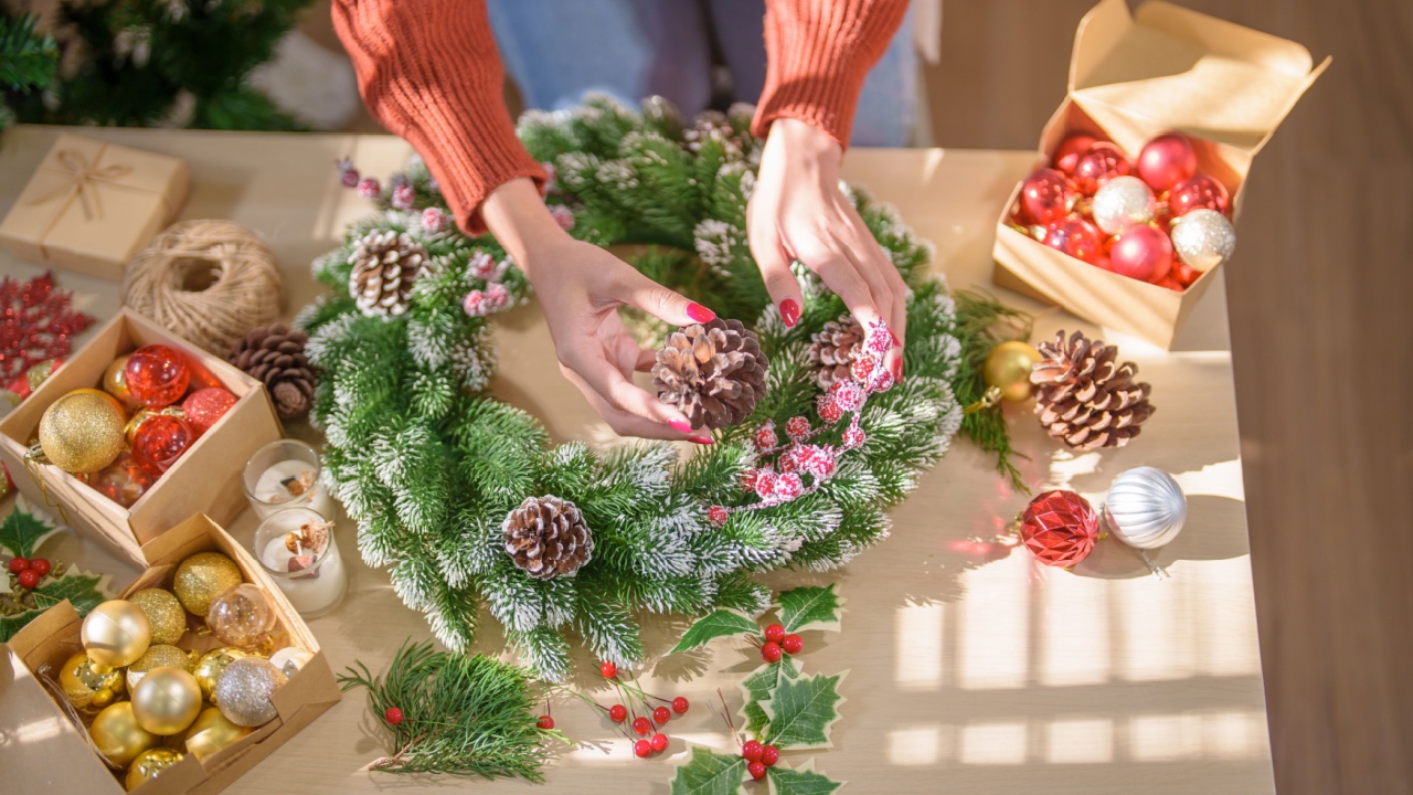Woman making mistletoe wreath Christmas wreath decoration with hand made DIY winter greenery florist hands making Christmas wreath beautiful mistletoe