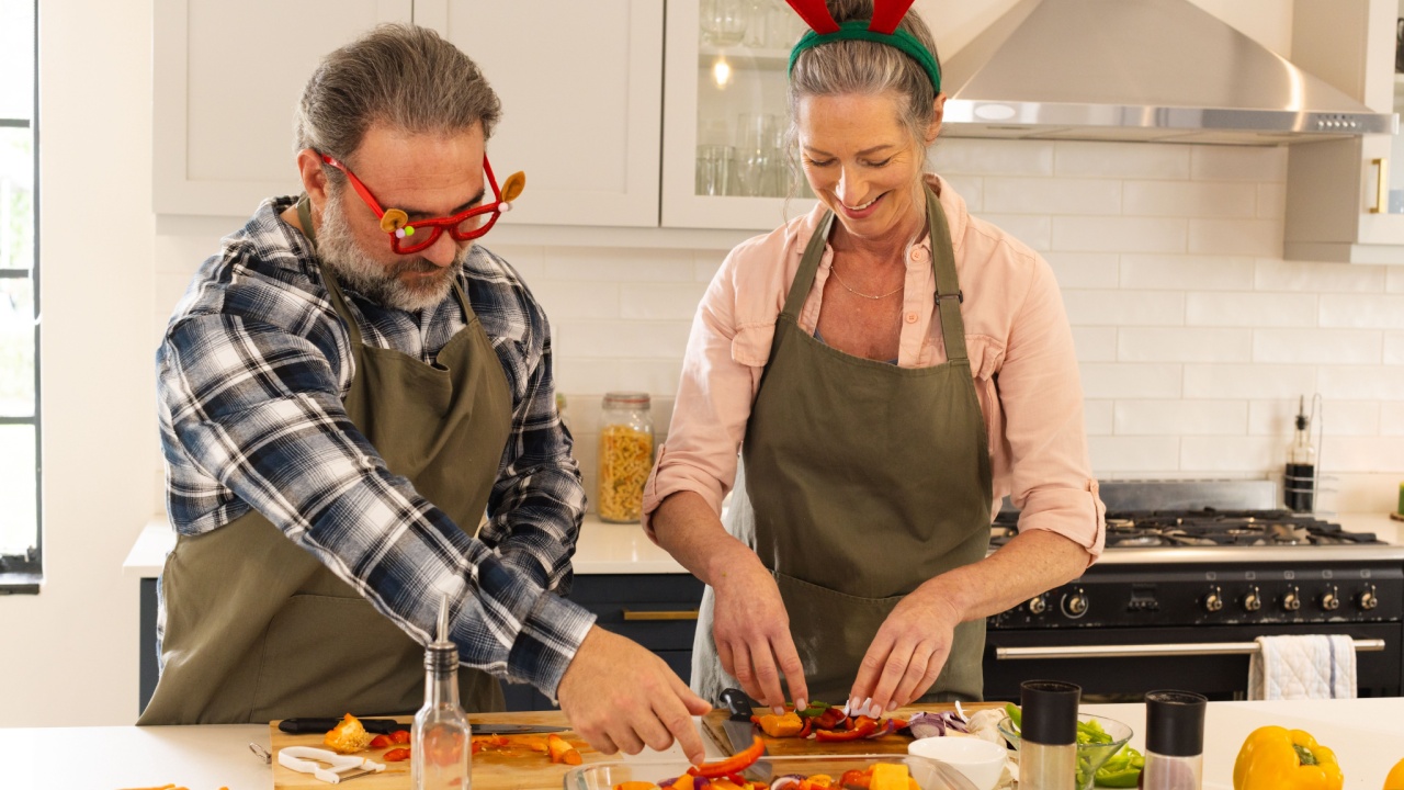 Christmas time, mature couple preparing festive meal in kitchen, at home. celebration, cooking, elderly, family, togetherness, joyful