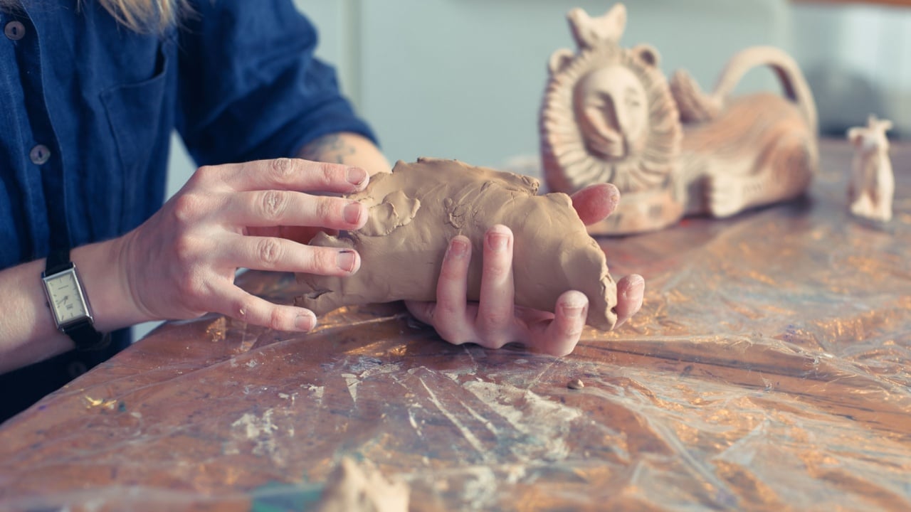 Crafting clay sculptures in a workshop with intricate designs and tools