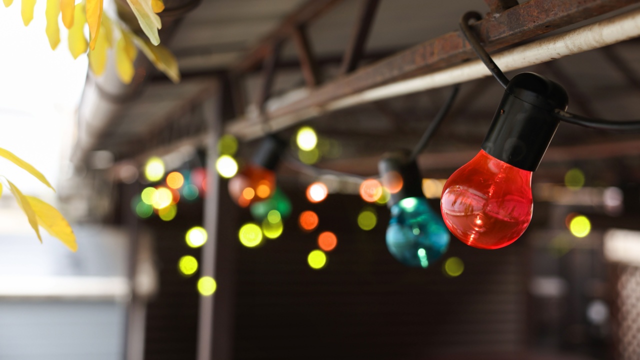 Christmas celebration. Canopy decorated with colorful light bulbs outdoors, closeup. Space for text