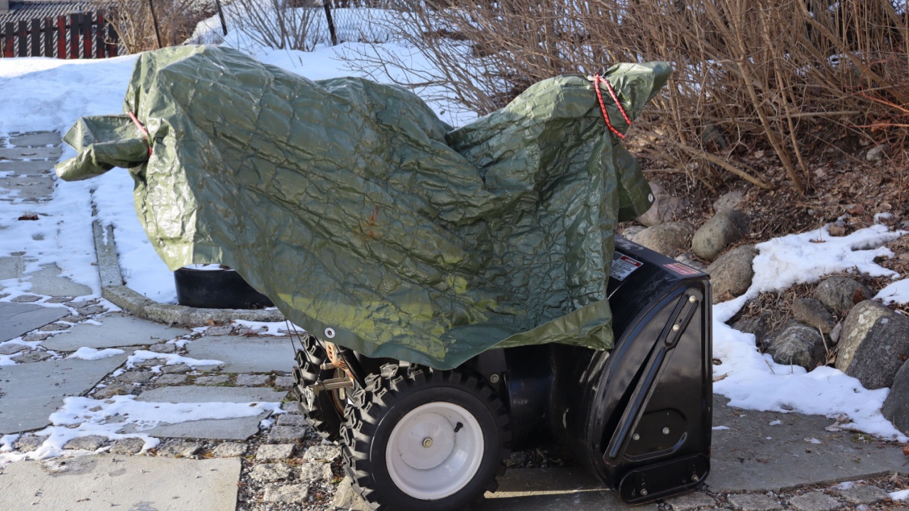 Norway 7 january 2025: snow blower covered with tarpaulin outdoors