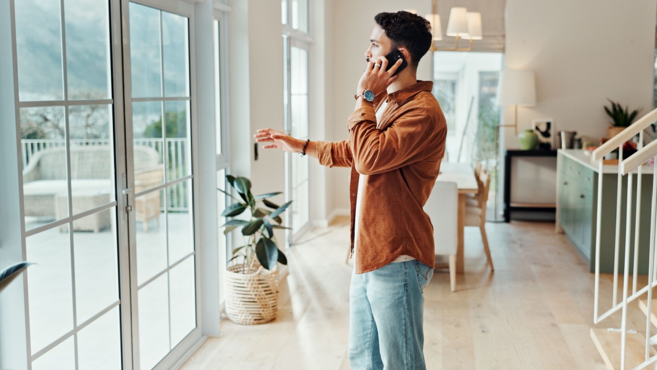 Man, phone call and real estate agent in home for appointment, open house or viewing. Conversation, property showcase and sale with realtor in apartment for communication, consulting or development