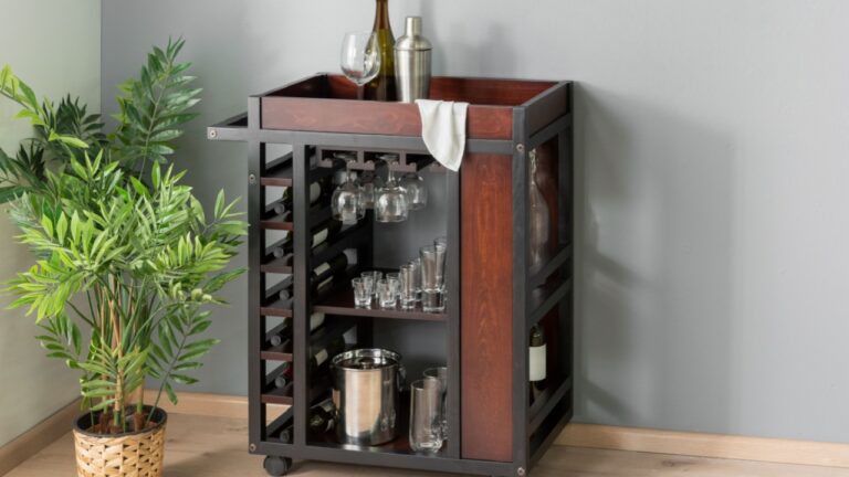 Industrial-inspired rolling bar cart with dark wood panels, metal frame, integrated wine rack, suspended glass hangers, a refined modern entertaining vibe, beautifully enhanced by lush indoor greenery