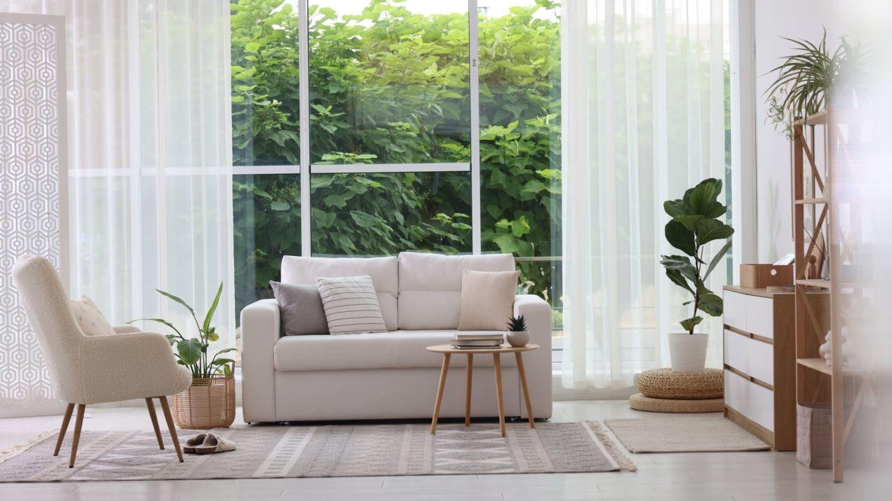Stylish sofa and other furniture in living room. Interior design