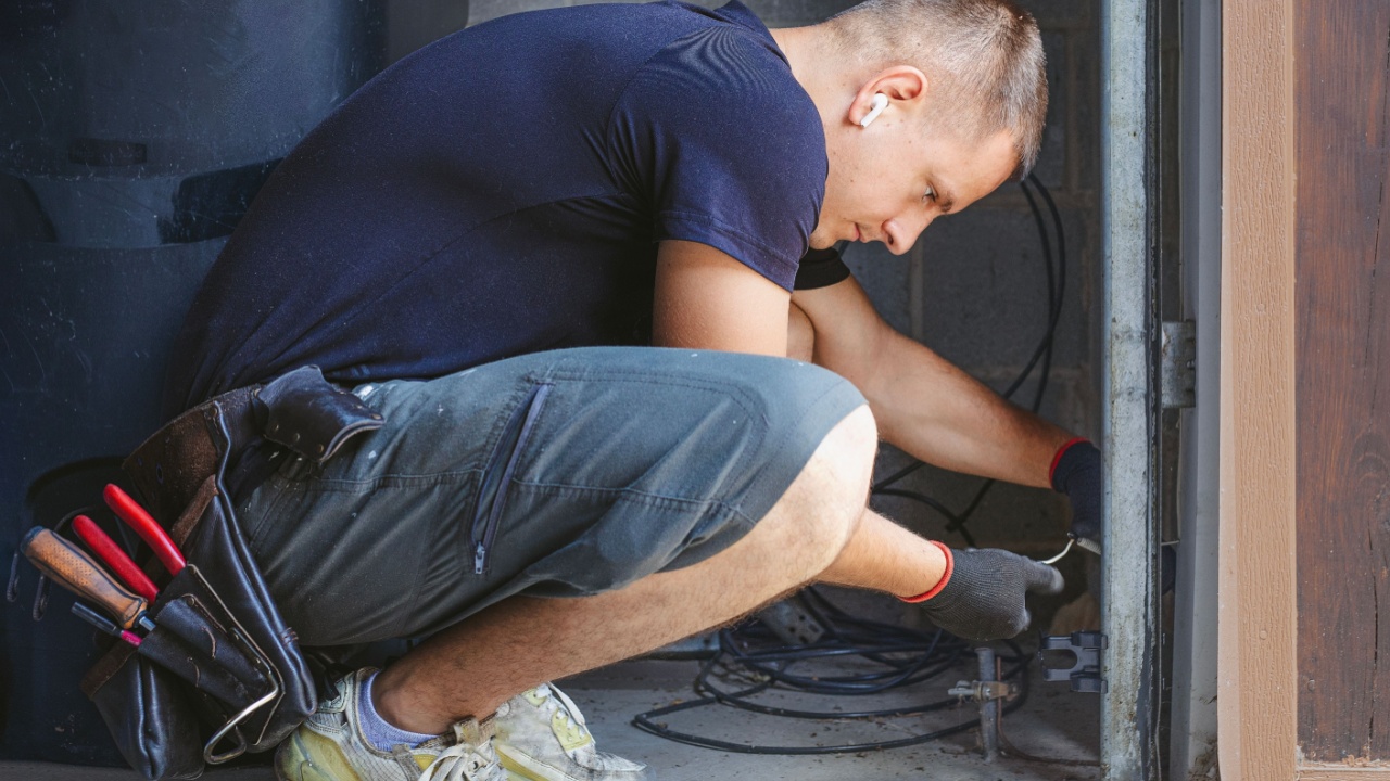 Man repairing garage door sensors