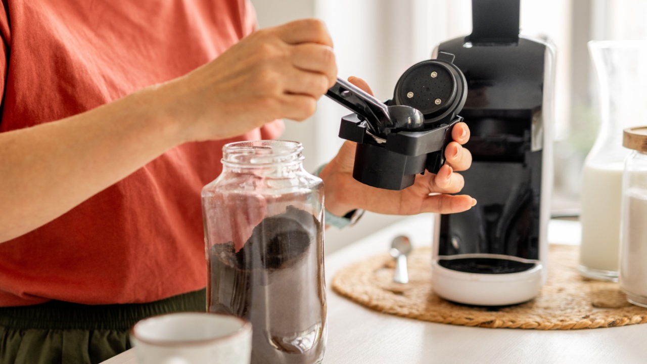 Woman Making Coffee In A Coffee Machine At Home, Close-Up