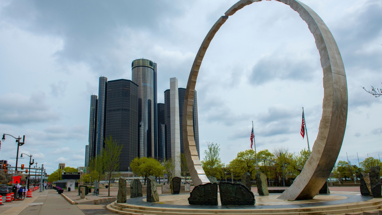 DETROIT, USA - APR. 19, 2025: Transcending arch monument at Hart Plaza with General Motors Renaissance Center RenCen at background in downtown Detroit, Michigan MI, USA. 