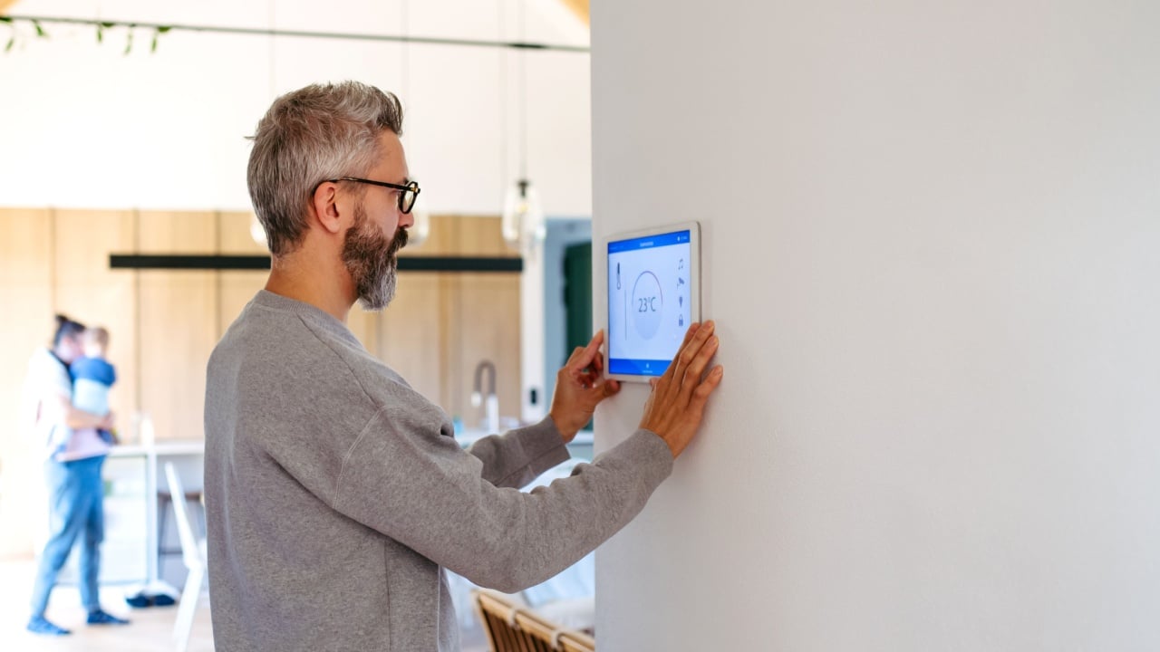 Man using smart home control panel.