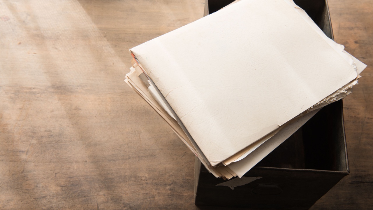 Old documents from an storage box or archives, with by-the-window type light coming in. Shallow depth of focus.