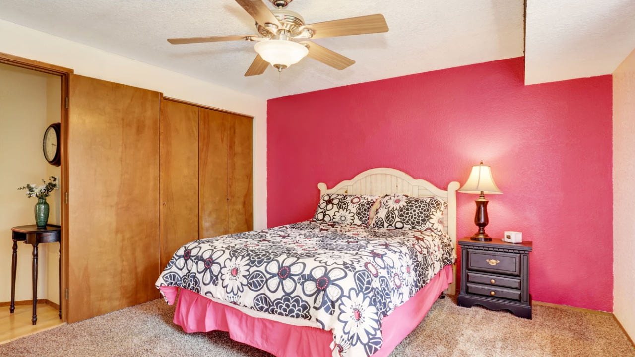 Modern pink bedroom with wardrobe and carpet floor. Also pink curtains. Northwest, USA