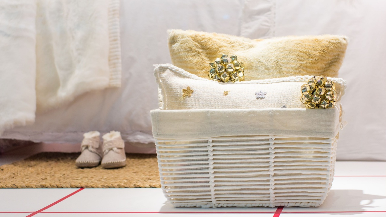 Christmas composition of basket with two pillows and christmas toys near a bed