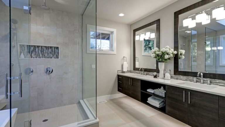 Spacious bathroom in gray tones with heated floors, walk-in shower, double sink vanity and skylights. Northwest, USA