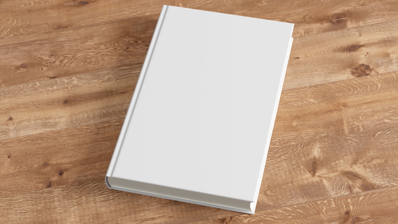 Blank white book cover on wooden background. Isolated with clipping path. 3d render