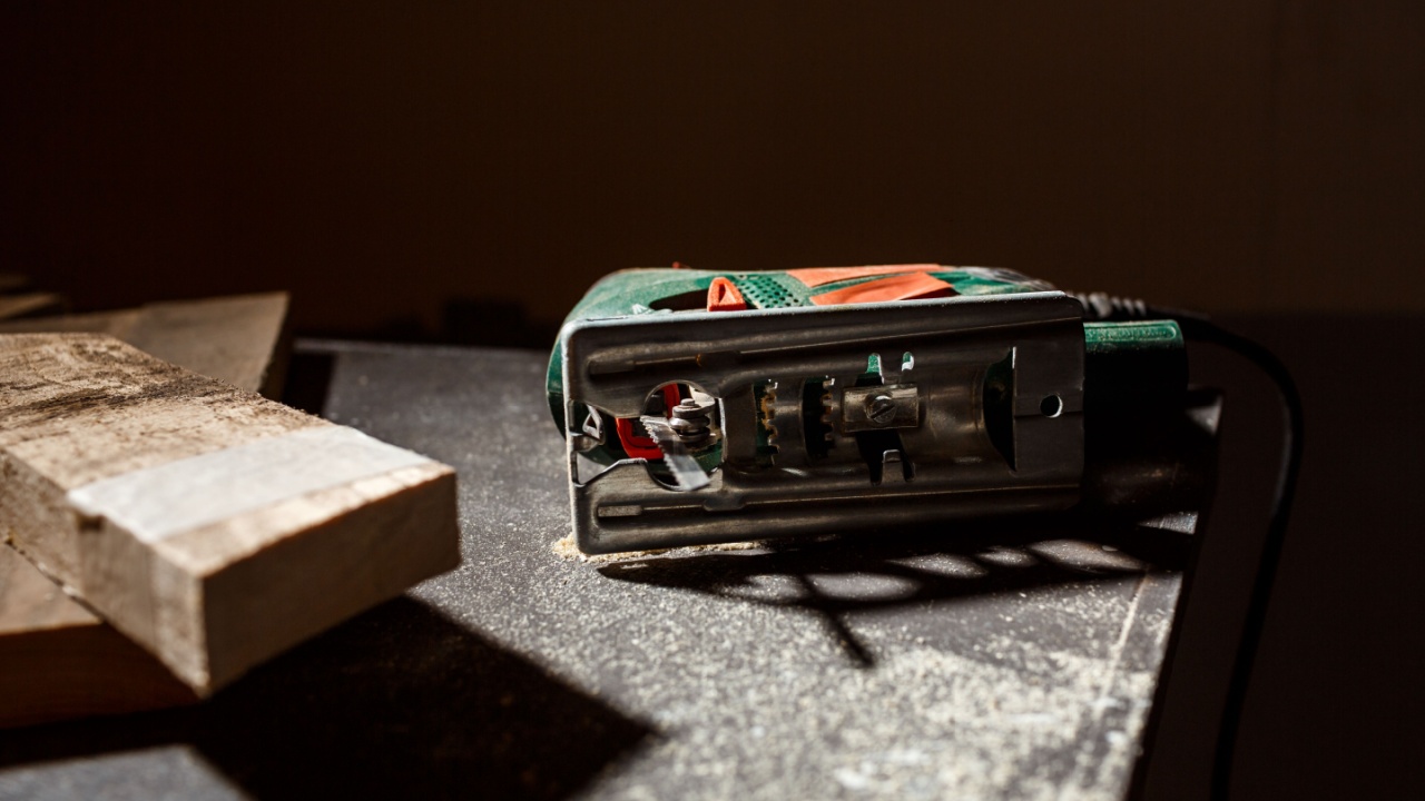 Close up photo of wood and fretsaw over dark background.