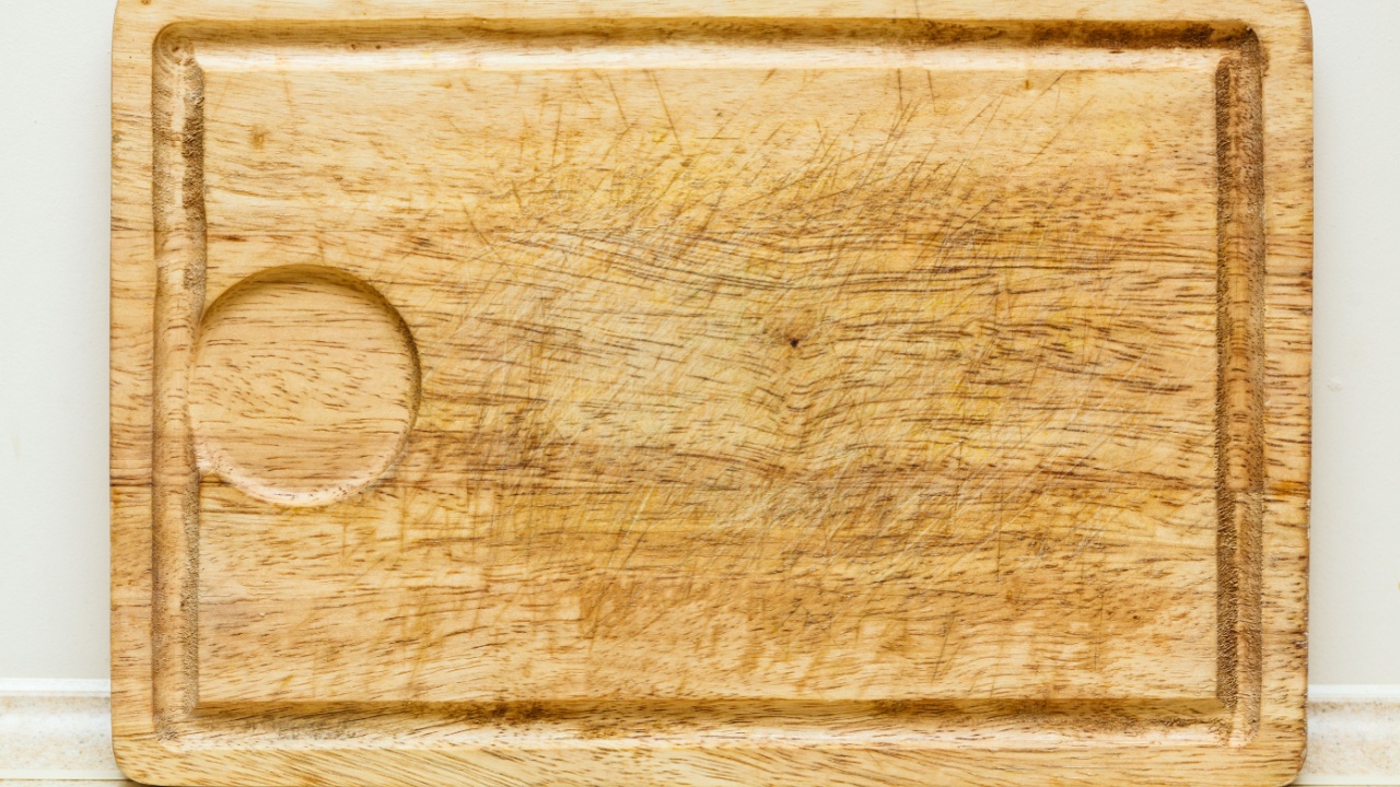 Home interior objects concept. Detailed top view closeup of old fashioned wooden kitchen board