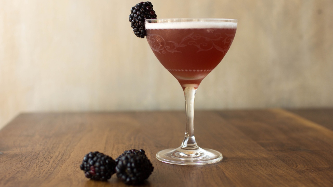 Blackberry cocktail with a wooden background