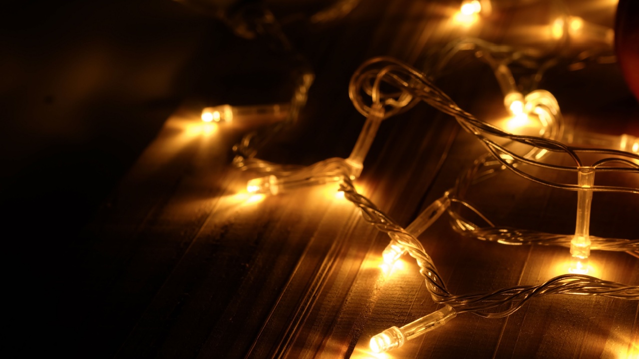 Abstract background warm lights decoration for Christmas ,happy new year and Halloween day on wood table in the dark