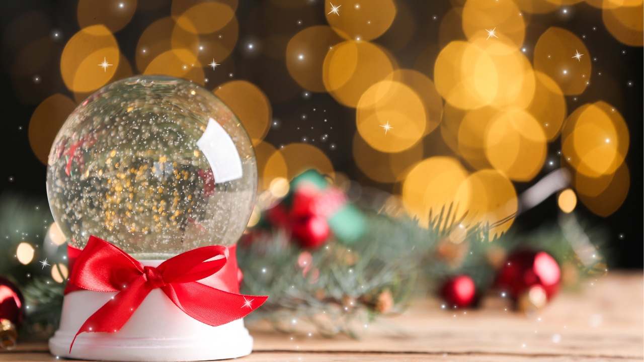 a snow globe in front of a Christmas tree
