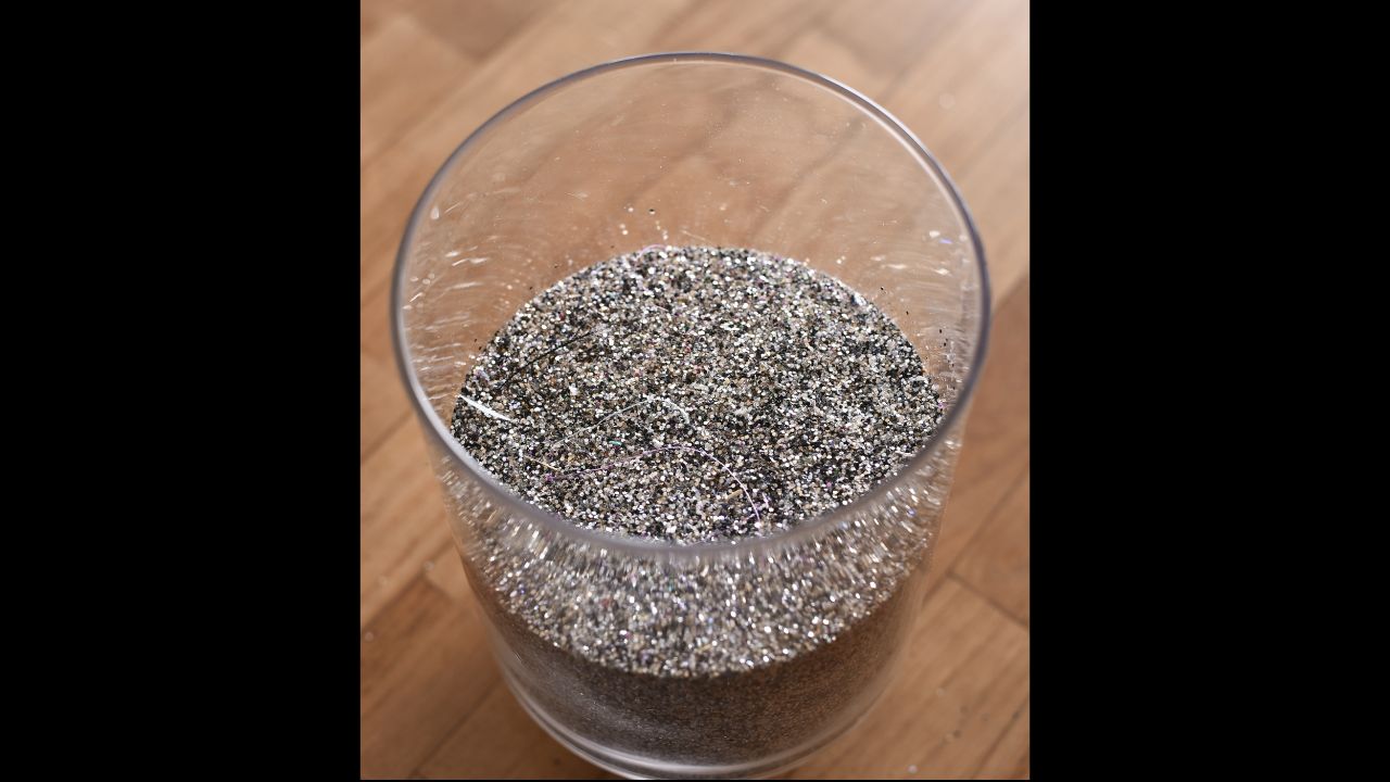 photo of glitter beads in a bowl on the wooden floor