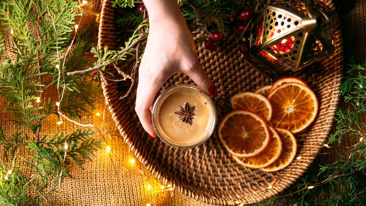 a basket with dried oranges, lamp, and hot toddy
