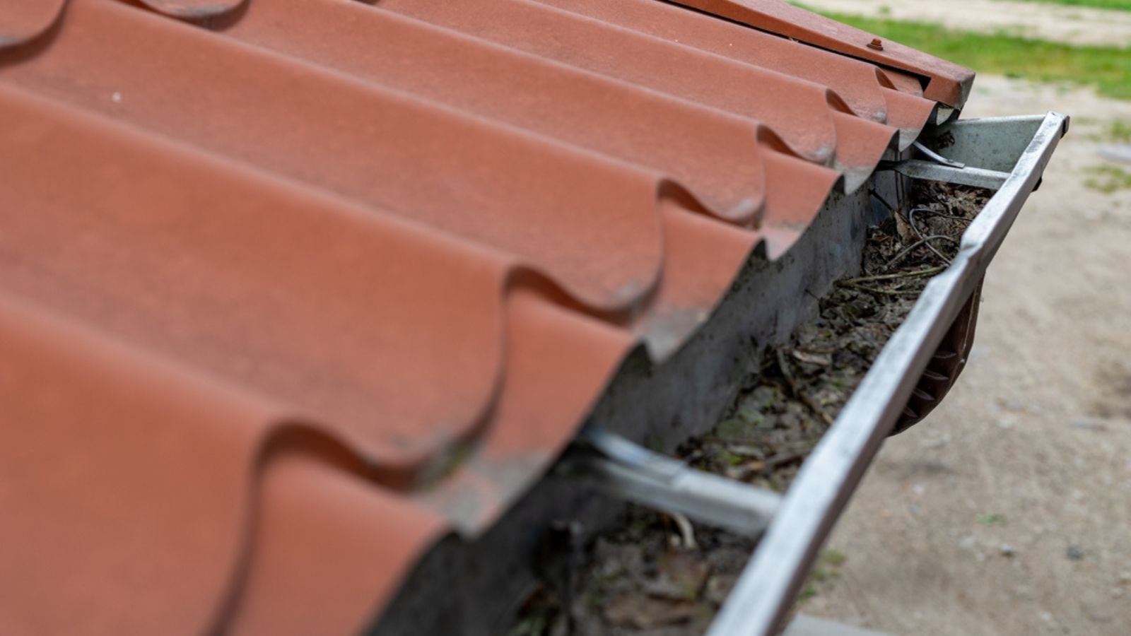 An old gutter in a detached house. Rainwater drainage from the roof