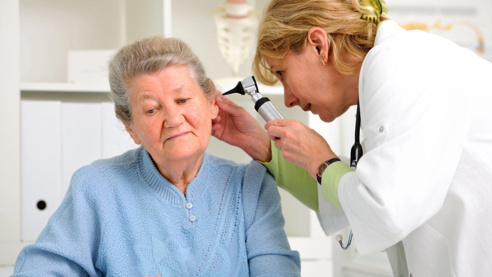 Otolaryngologycal exam doctor examining senior patient's ears