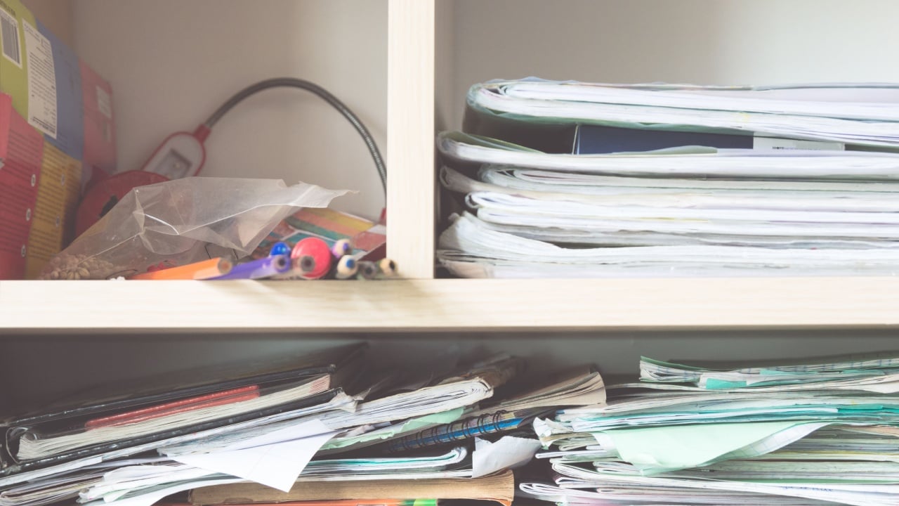 Stacks of notebooks and school supplies - a mess in the closet