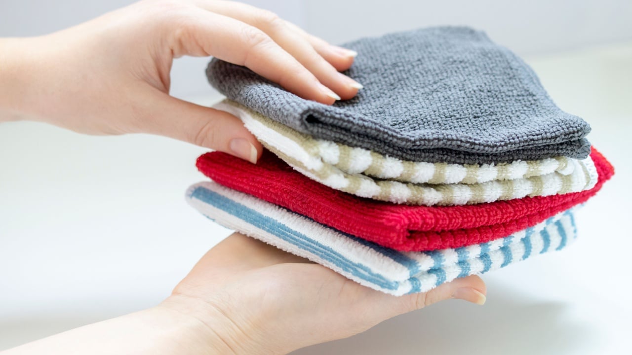 hand takes a microfiber cloth