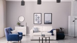 Stylish living room interior with white sofa, armchair and small coffee table