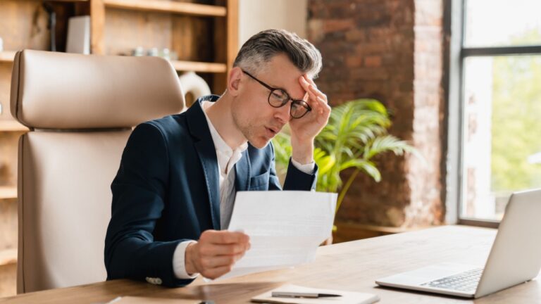 Overload in office. Business problems, debt, credit loan bankruptcy. Caucasian mature middle-aged businessman freelancer ceo boss lawyer receive sad news, bills, fired, mortgage divorce issues