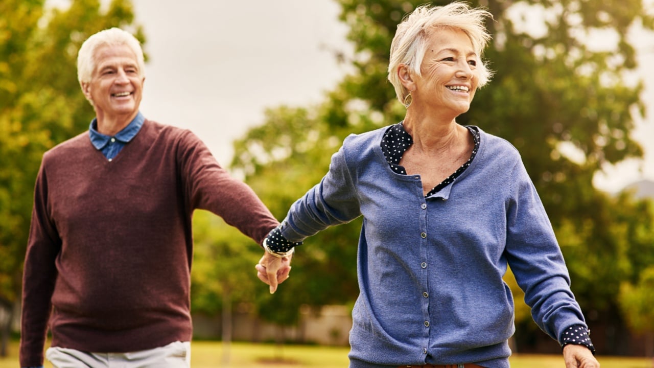 Love keeps a marriage alive. Shot of a happy senior couple going for a walk in the park.