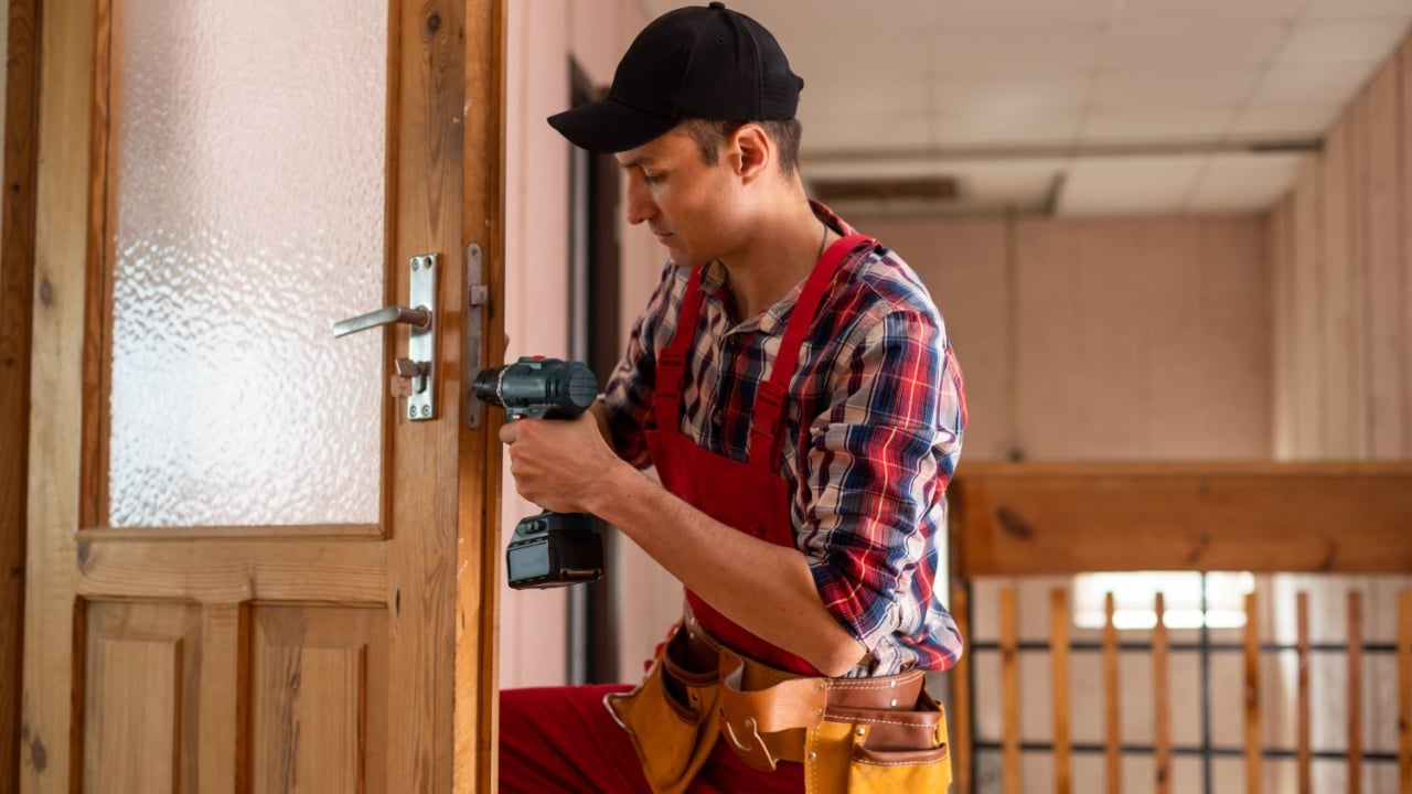 handyman repair the door lock in the room.