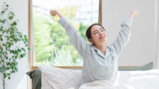 Young Asian woman waking up