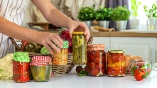 Woman jar preserve vegetables in the kitchen