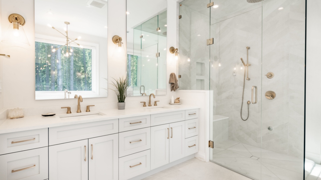 Interior bathroom photography with glass doors subway tile freestanding tub and pedestal sink slate floors granite counter towels claw footed bathtub and view windows